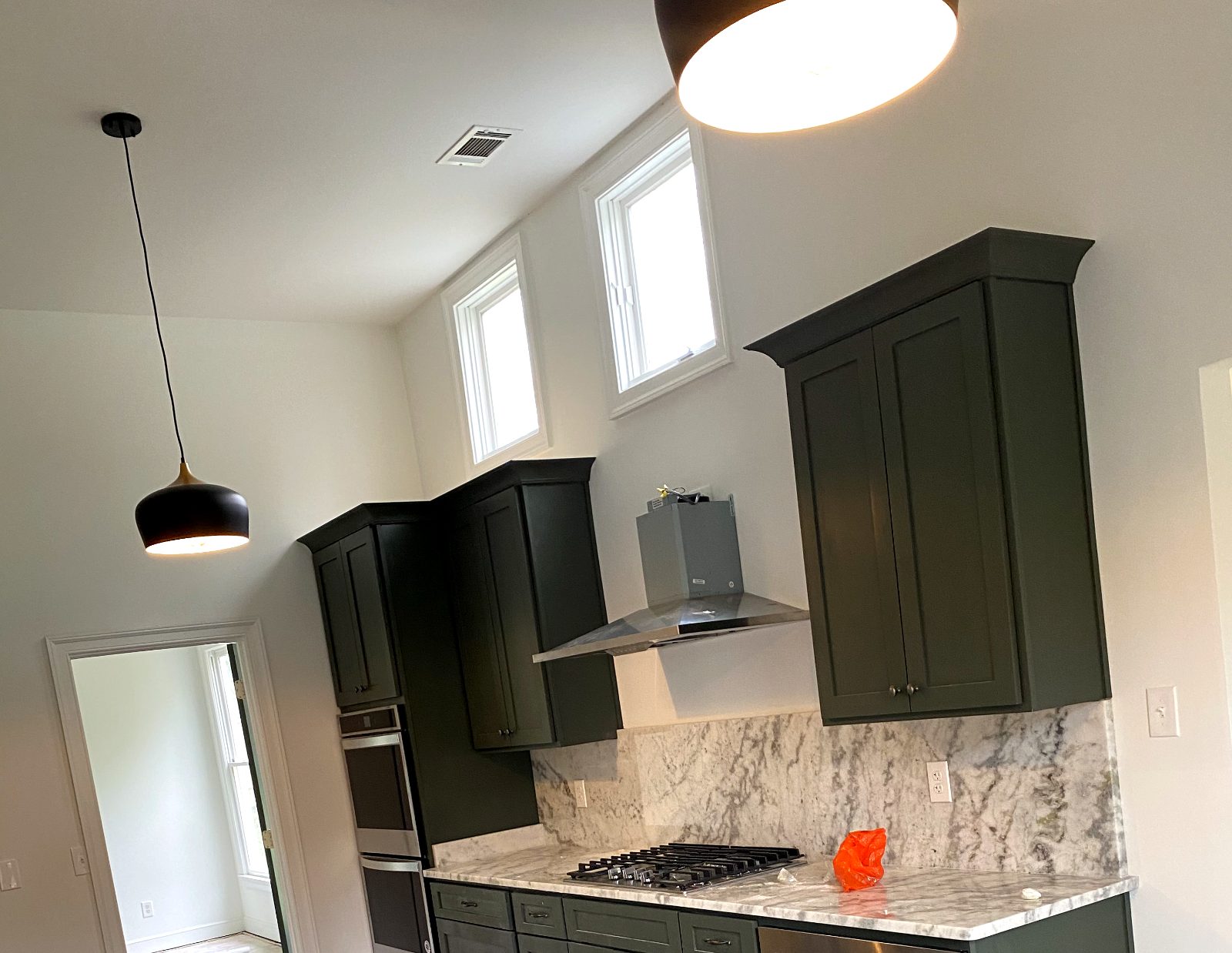 Pendant and under-cabinet lighting installed in a remodeled residential kitchen.