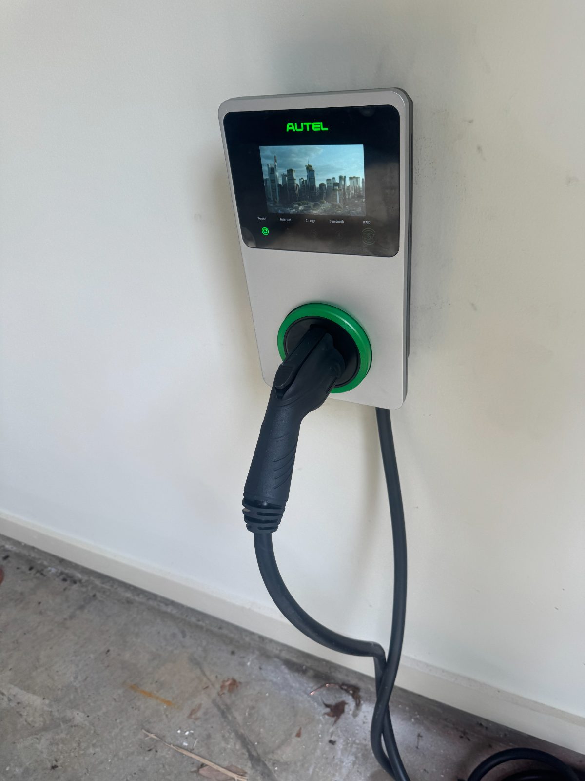 Autel Level 2 EV charger mounted on a garage wall.